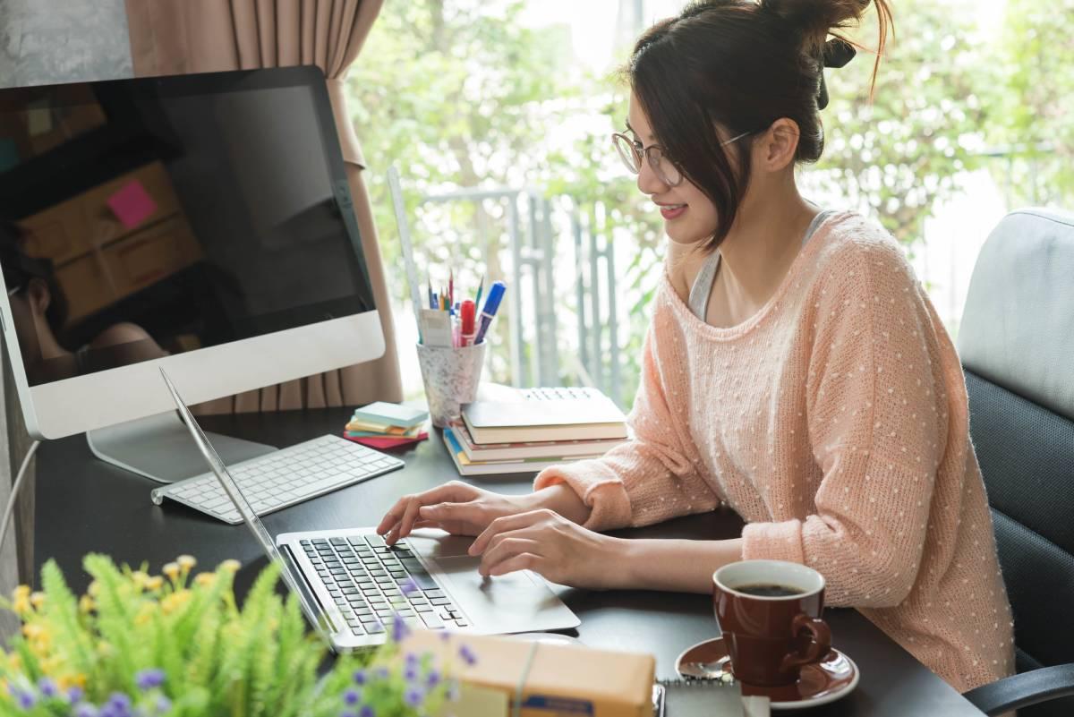 Smiling woman working on laptop